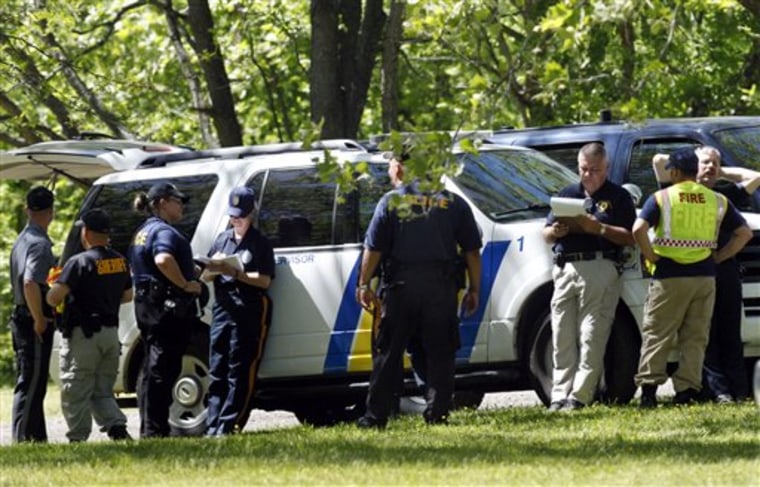 Police and emergency officals gather in a park Tuesday in Burlington Township, N.J., not far from where a car belonging to Sarah Townsend, 18, of Florence, N.J., was found.
